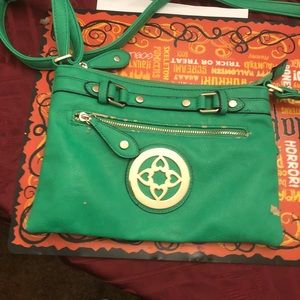 Women’s green and gold cross keg bag